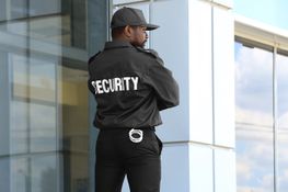 Security guard touching an earpiece, listening to information